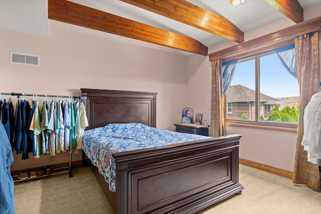 carpeted bedroom featuring lofted ceiling with beams