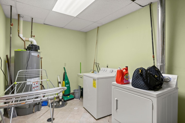 washroom featuring washer and clothes dryer and light tile patterned flooring