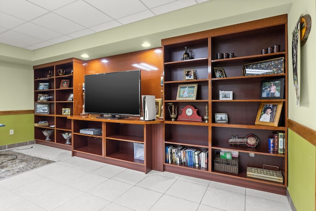 tiled living room with a paneled ceiling