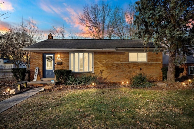 view of front of property with a yard