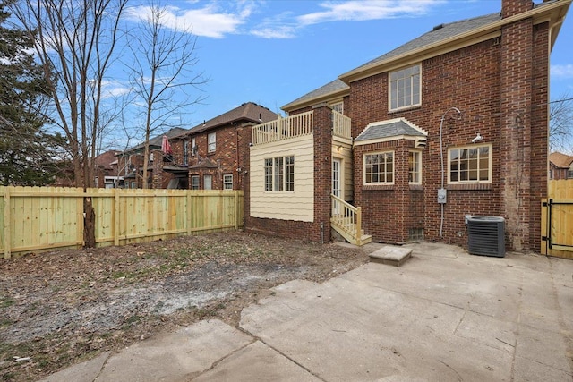 rear view of house featuring cooling unit and a patio