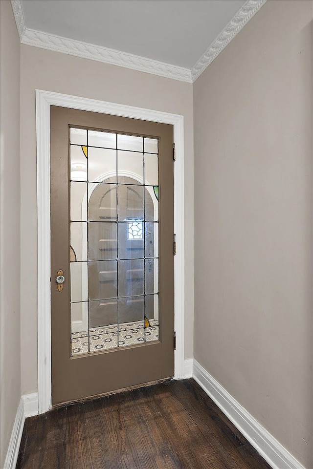 doorway featuring ornamental molding and dark wood-type flooring