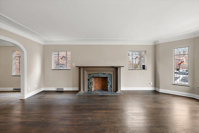 unfurnished living room featuring crown molding and dark wood-type flooring