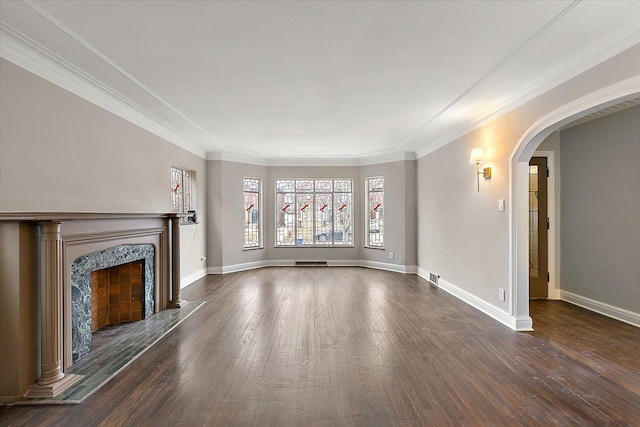 unfurnished living room featuring dark hardwood / wood-style floors, crown molding, and a premium fireplace