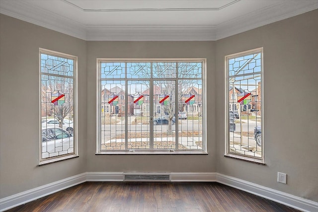 unfurnished dining area featuring a wealth of natural light, dark wood-type flooring, and ornamental molding