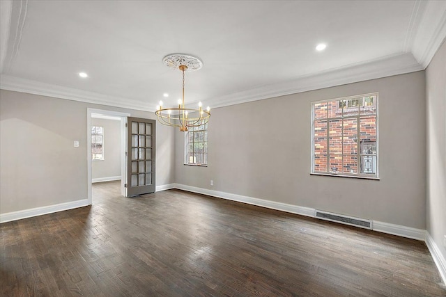 unfurnished dining area with plenty of natural light, ornamental molding, dark wood-type flooring, and a chandelier