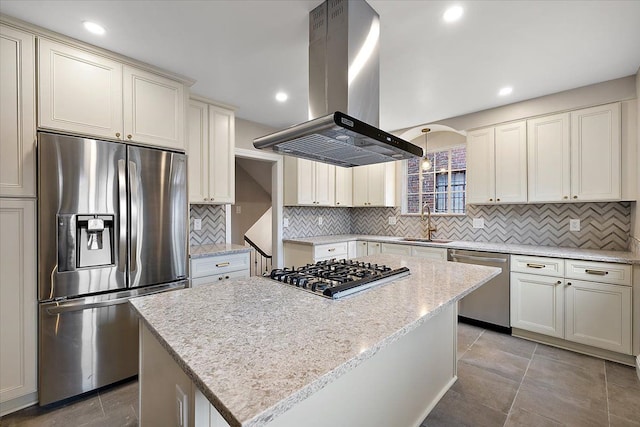 kitchen with a center island, sink, appliances with stainless steel finishes, light stone counters, and island exhaust hood