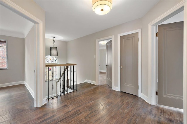 hallway with dark hardwood / wood-style flooring