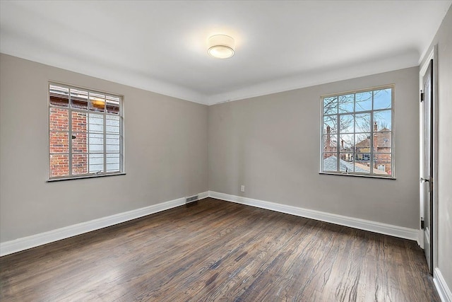 spare room with dark hardwood / wood-style floors