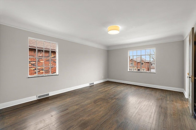 unfurnished room featuring dark hardwood / wood-style flooring and ornamental molding