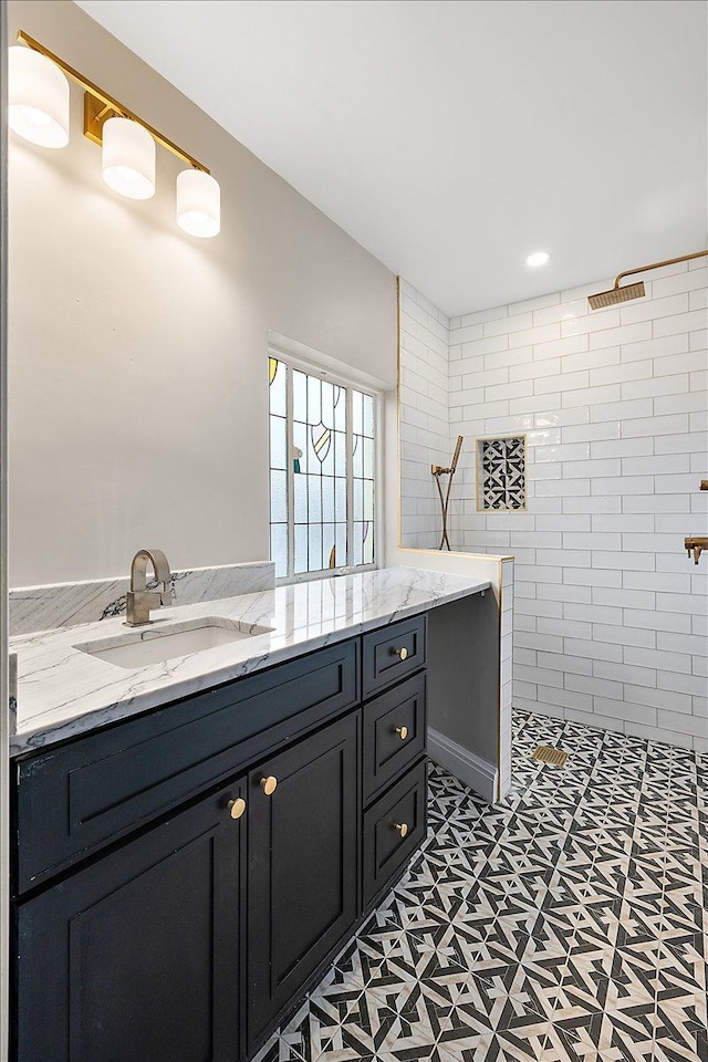 bathroom featuring vanity and a tile shower