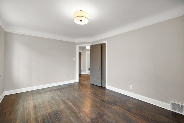 spare room with dark hardwood / wood-style floors