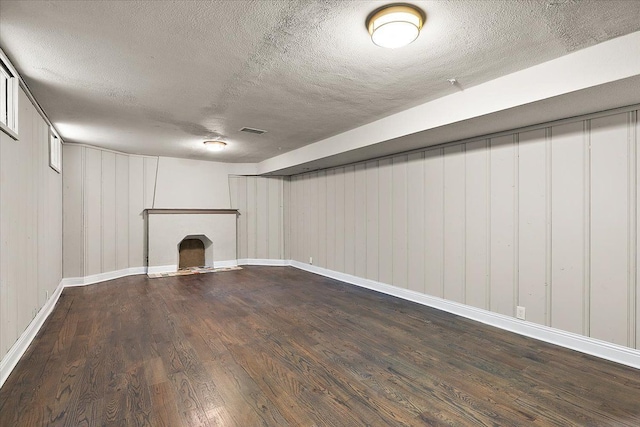 basement featuring hardwood / wood-style floors and a textured ceiling