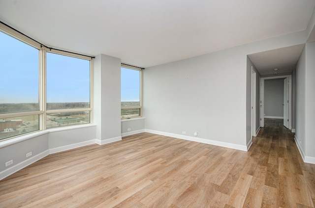 unfurnished room with light hardwood / wood-style flooring