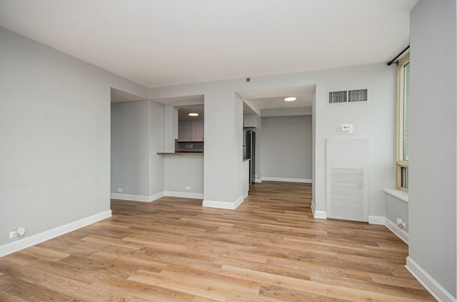 unfurnished room with light hardwood / wood-style floors