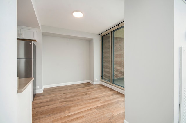 spare room featuring light hardwood / wood-style flooring