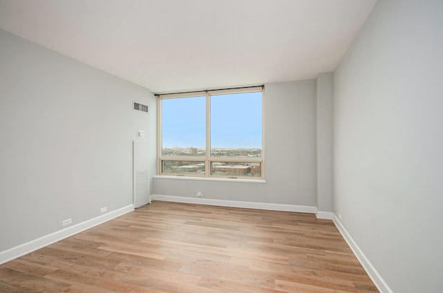 spare room with light hardwood / wood-style floors