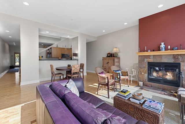 living room with a fireplace and light hardwood / wood-style floors