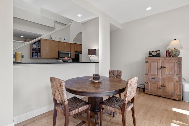 dining space featuring light wood-type flooring