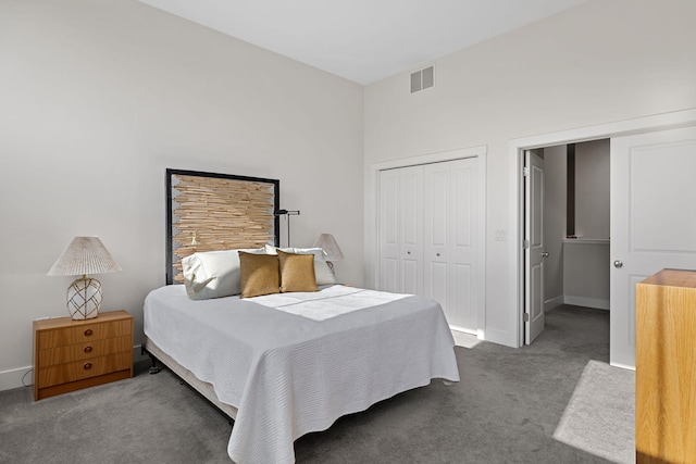 bedroom featuring dark carpet and a closet