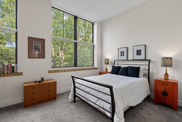 carpeted bedroom with lofted ceiling