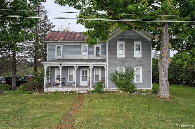 view of front of house with covered porch and a front yard