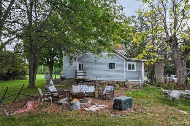 rear view of property featuring a yard and an outdoor hangout area