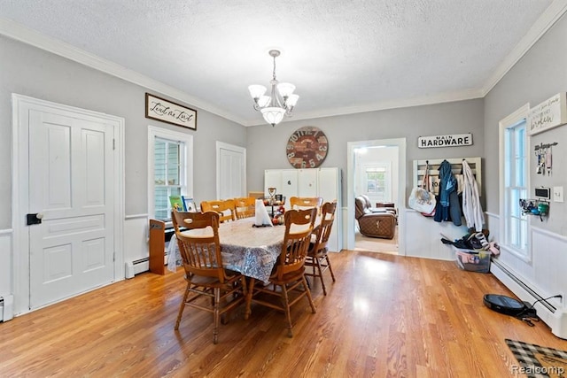 dining space with a chandelier, a baseboard radiator, and a textured ceiling