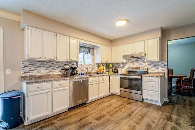 kitchen with wood-type flooring, white cabinetry, and appliances with stainless steel finishes