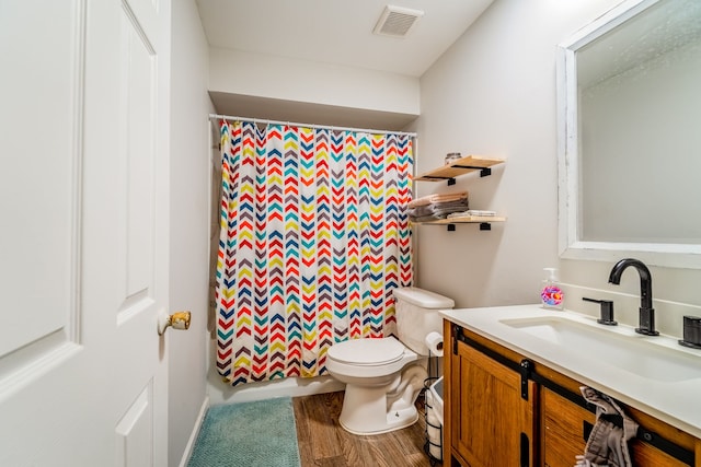 bathroom with hardwood / wood-style floors, vanity, toilet, and a shower with curtain