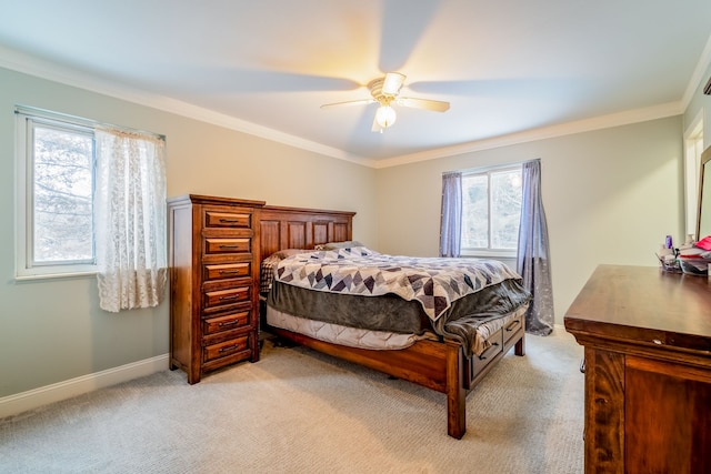 carpeted bedroom featuring ceiling fan and crown molding