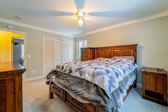 bedroom with light carpet, a closet, ceiling fan, and crown molding