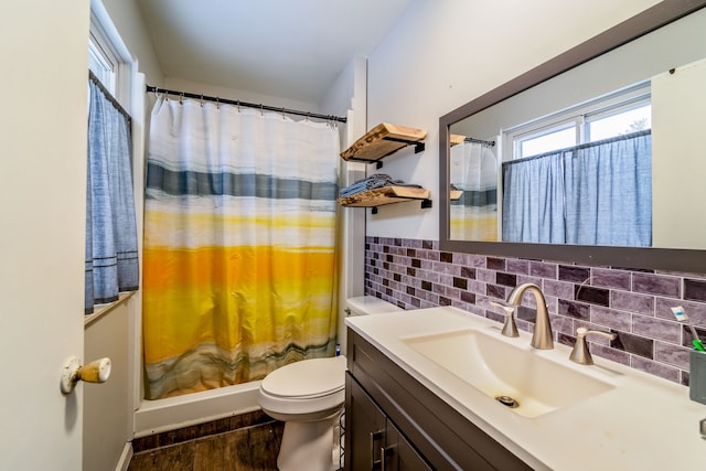 bathroom with vanity, backsplash, hardwood / wood-style flooring, toilet, and walk in shower