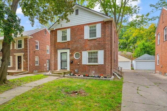 view of front of house featuring a garage, a front lawn, and an outdoor structure