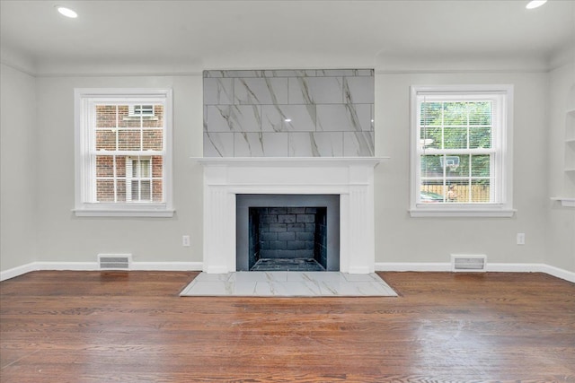 unfurnished living room with dark hardwood / wood-style floors and a fireplace