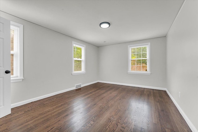 empty room with dark wood-type flooring