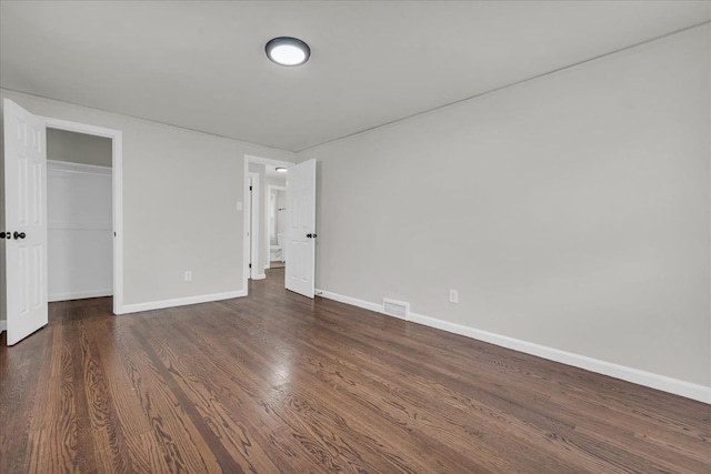 unfurnished bedroom featuring dark hardwood / wood-style floors and a closet