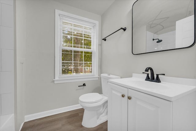 bathroom featuring toilet, vanity, and hardwood / wood-style flooring