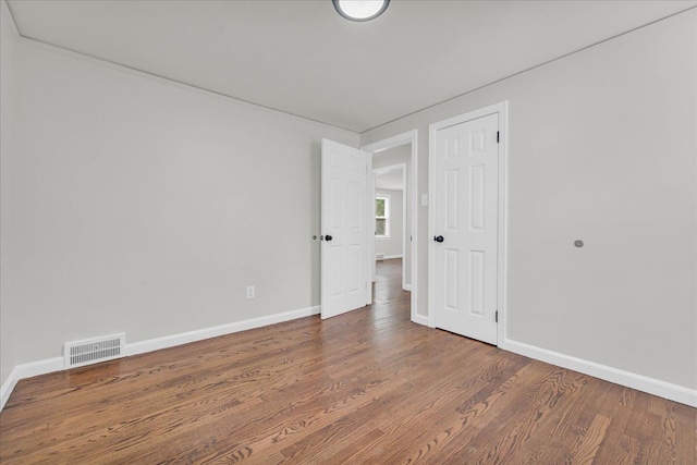 unfurnished room with hardwood / wood-style flooring