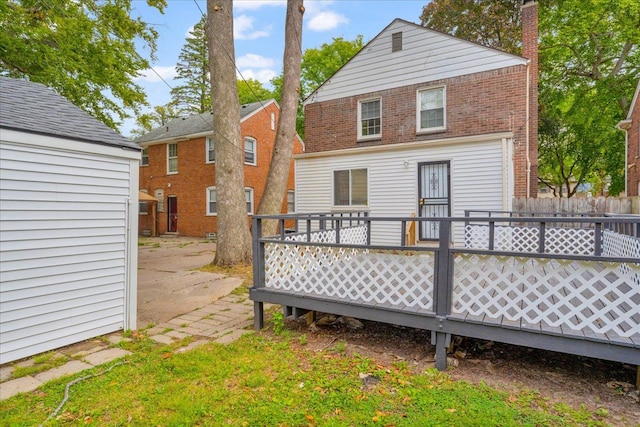 rear view of property featuring a wooden deck