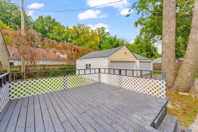 wooden terrace with an outbuilding and a garage