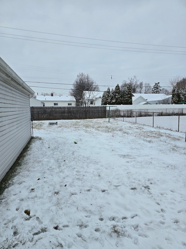 view of yard layered in snow