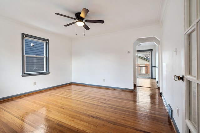 unfurnished room featuring ceiling fan, hardwood / wood-style floors, and crown molding