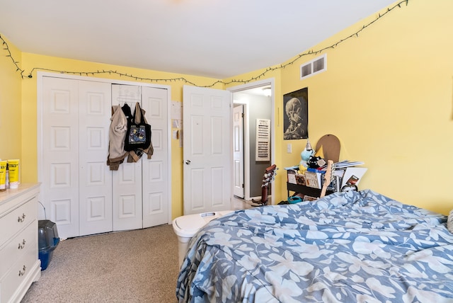 bedroom with light carpet and a closet