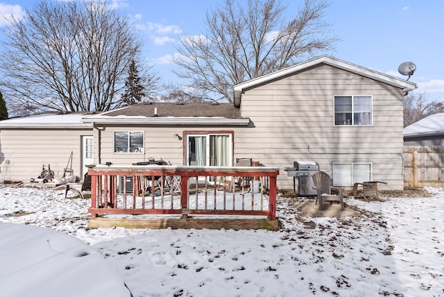 snow covered property with a wooden deck