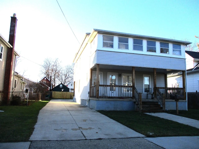 view of front facade with a front lawn and a porch