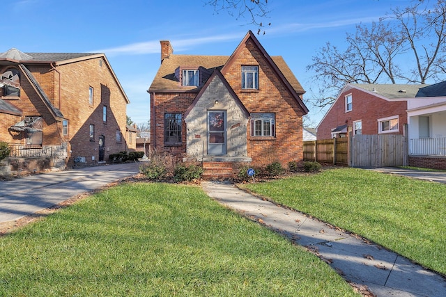 tudor-style house with a front yard