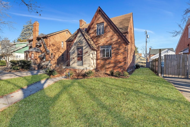 tudor house featuring a front lawn