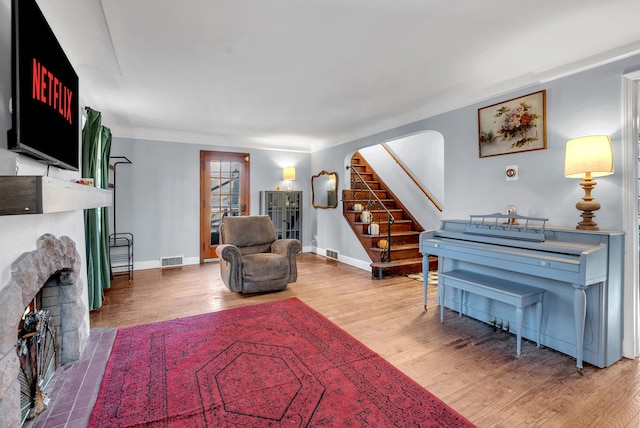 sitting room with wood-type flooring and a fireplace