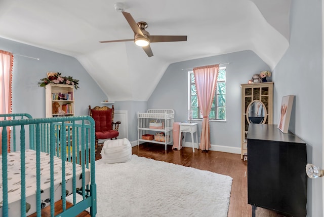 bedroom featuring ceiling fan, dark wood-type flooring, and vaulted ceiling